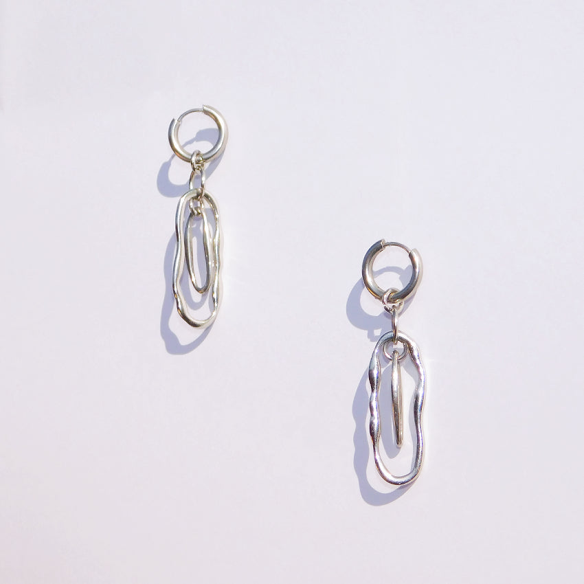 Pair of stainless steel silver drop earrings on a white background
