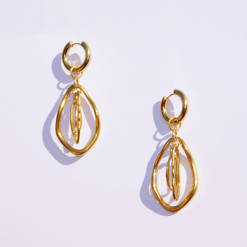 Stainless steel 18k plated gold earrings in a light grey background