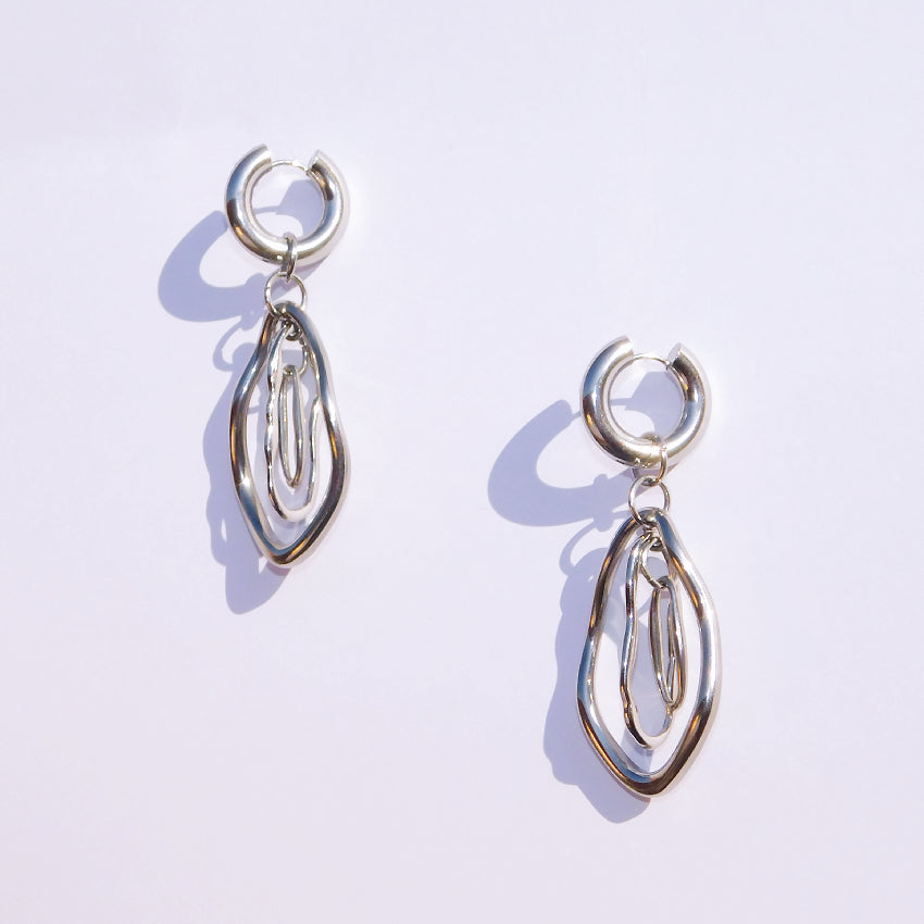 Pair of stainless steel silver earrings on a white background